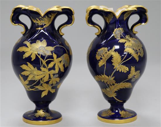 A pair of Spode blue ground baluster vases, gilt decorated with flowering shrubs 7in.